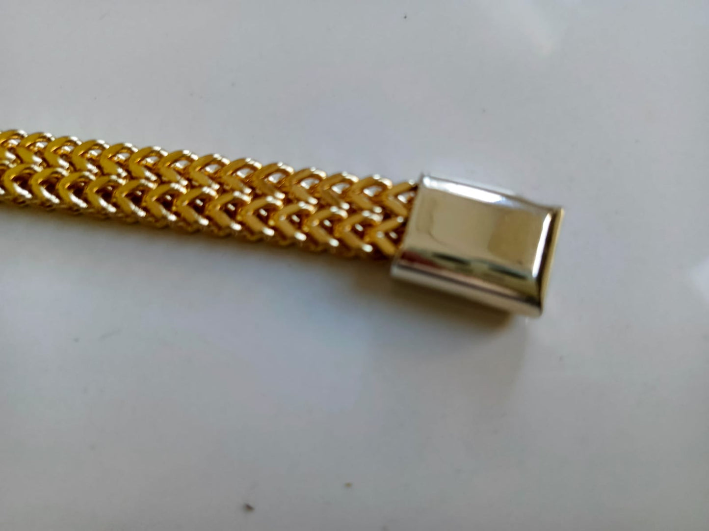 Gold chain with a clasp on a white background